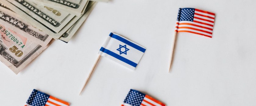 flags of usa and israel placed near dollar banknotes